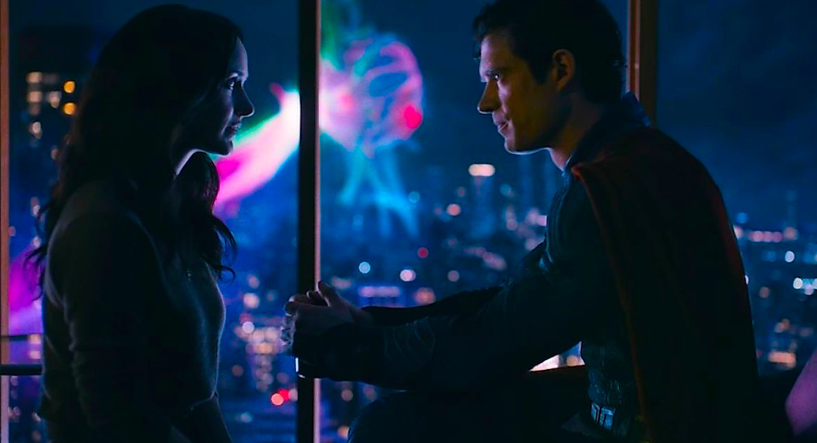 David Corenswet and Rachel Brosnahan in Superman talking with a monster in the background