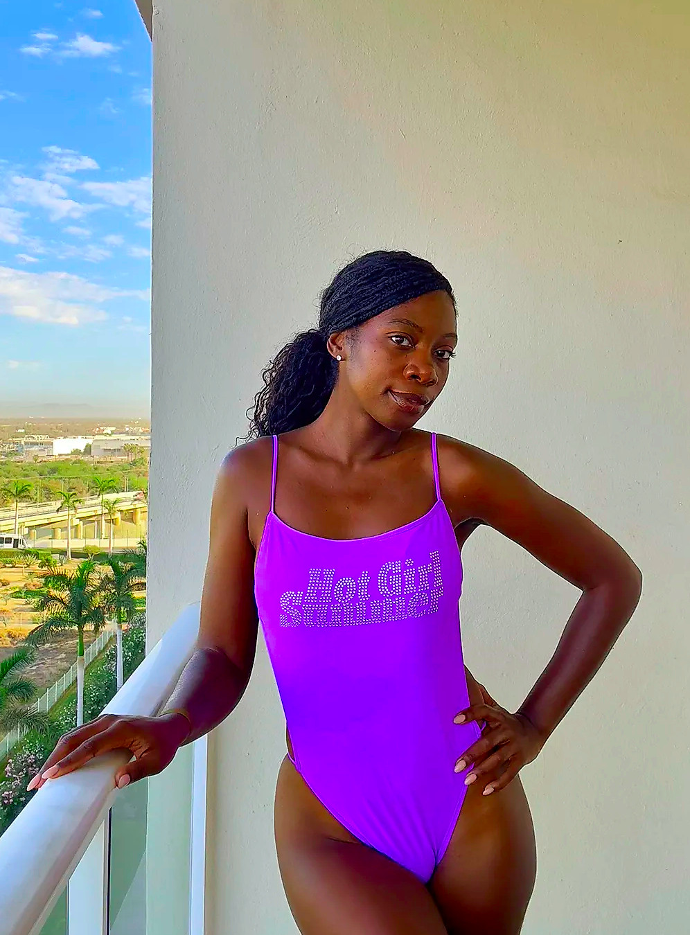 Jasmine Phillips wearing a purple bathing suit