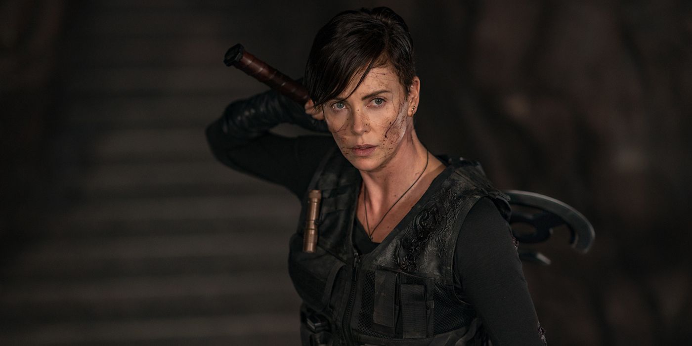 Andy (Charlize Theron) holding an ax over her shoulder in Netflix's The Old GuaRd. 