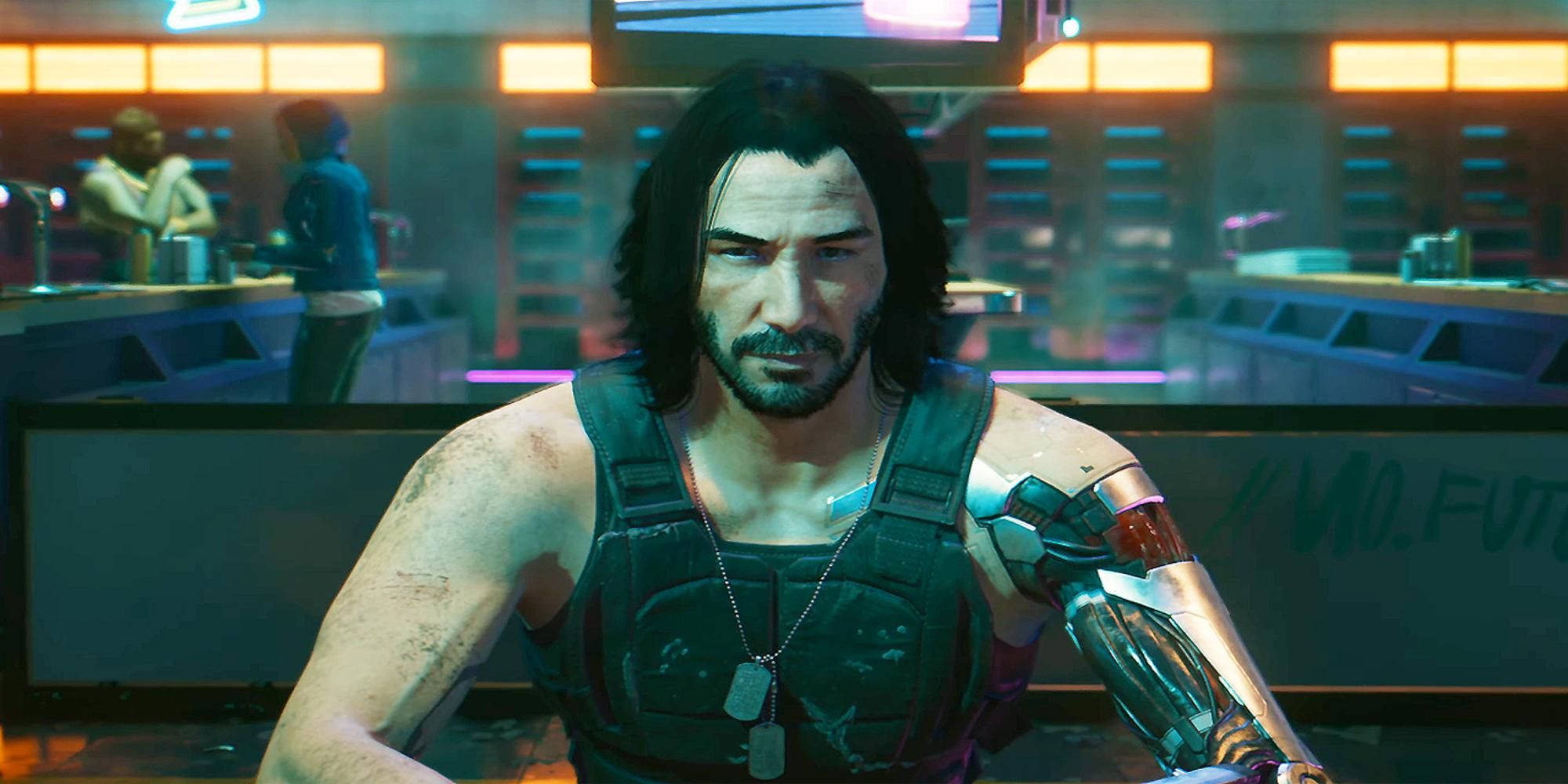 Johnny Silverhand played by Keanu Reeves siting behind a table in Cyberpunk 2077