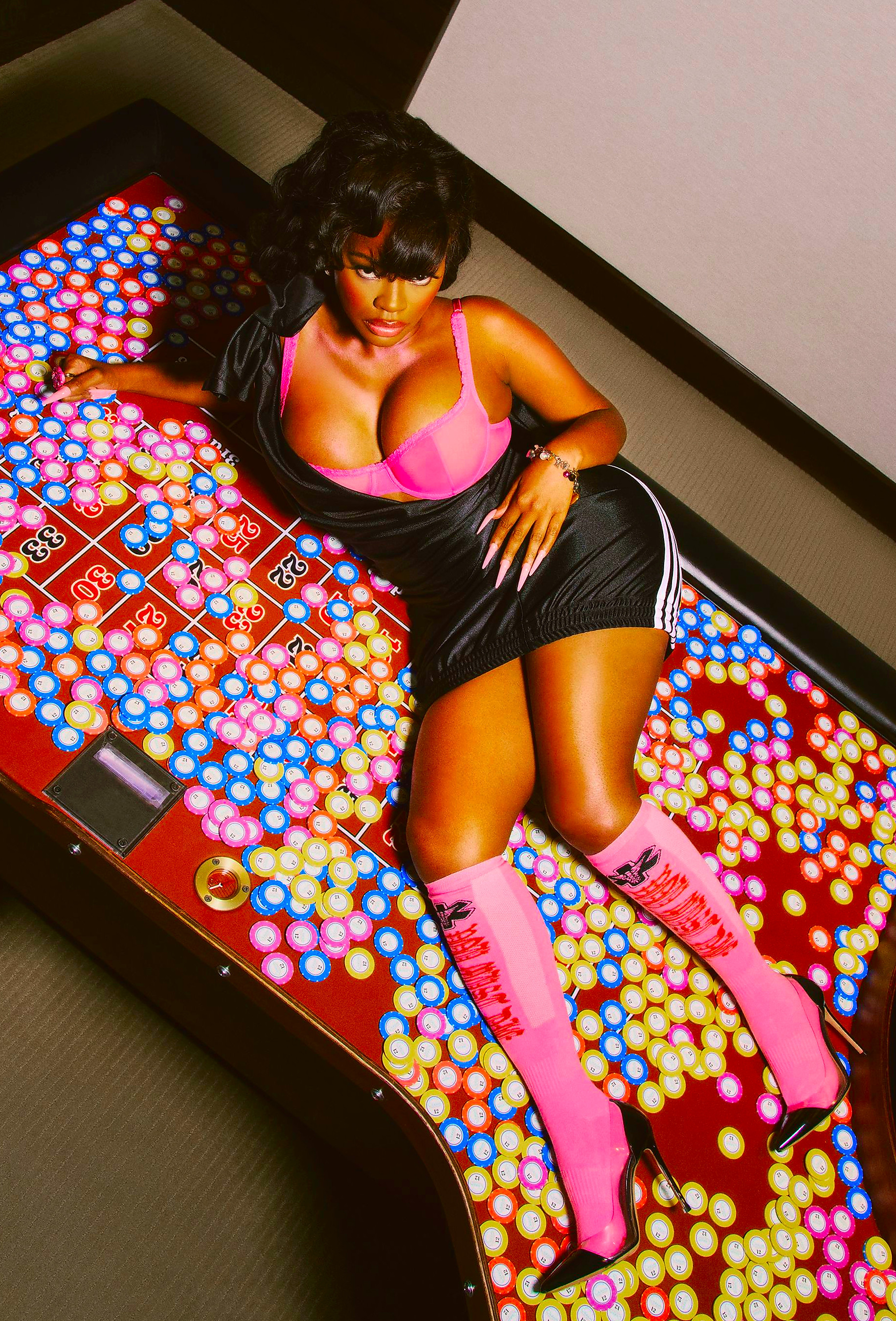 a woman poses on a roulette table covered with colored chips