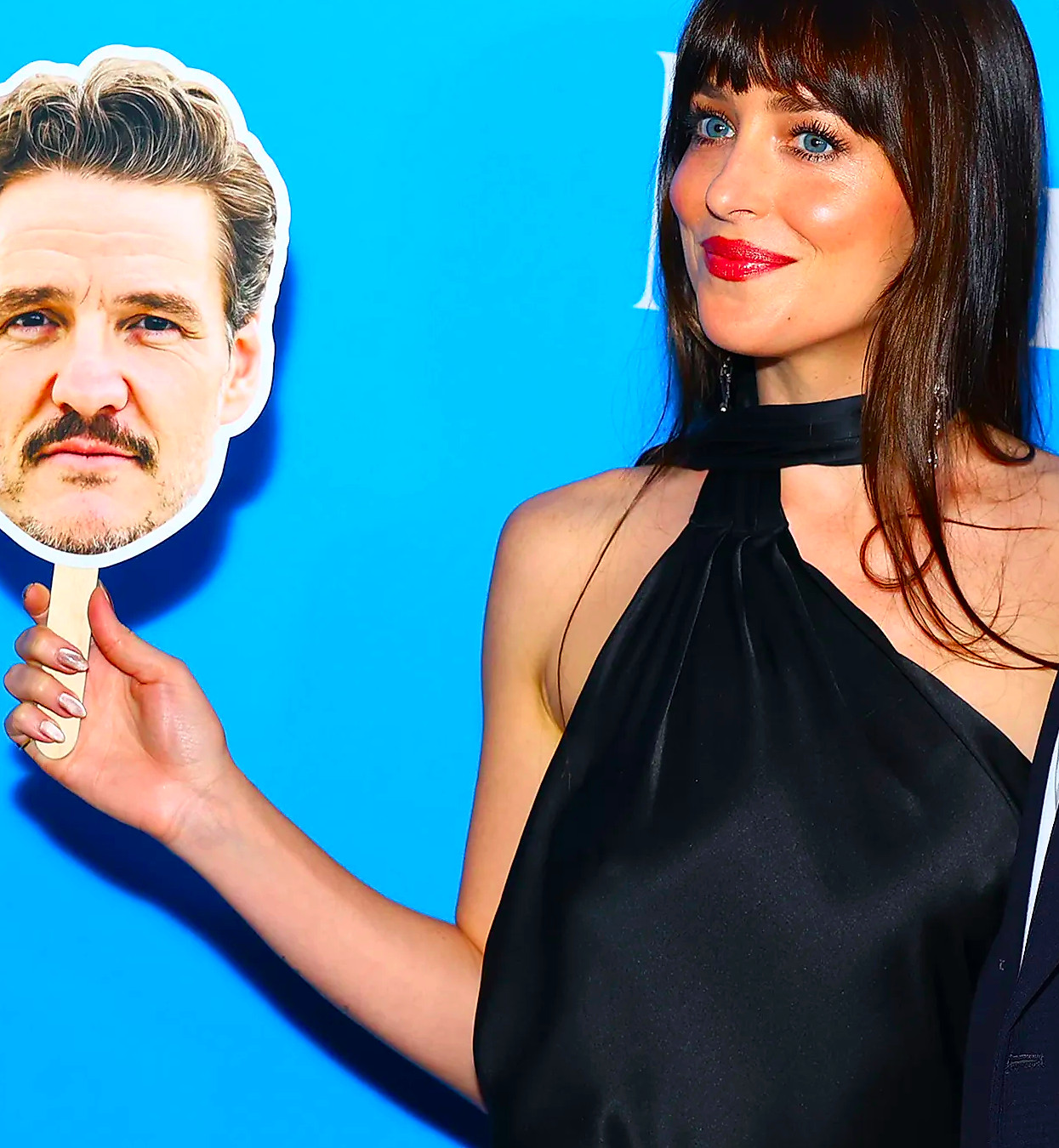 Dakota Johnson holding a Pedro Pascal cut-out