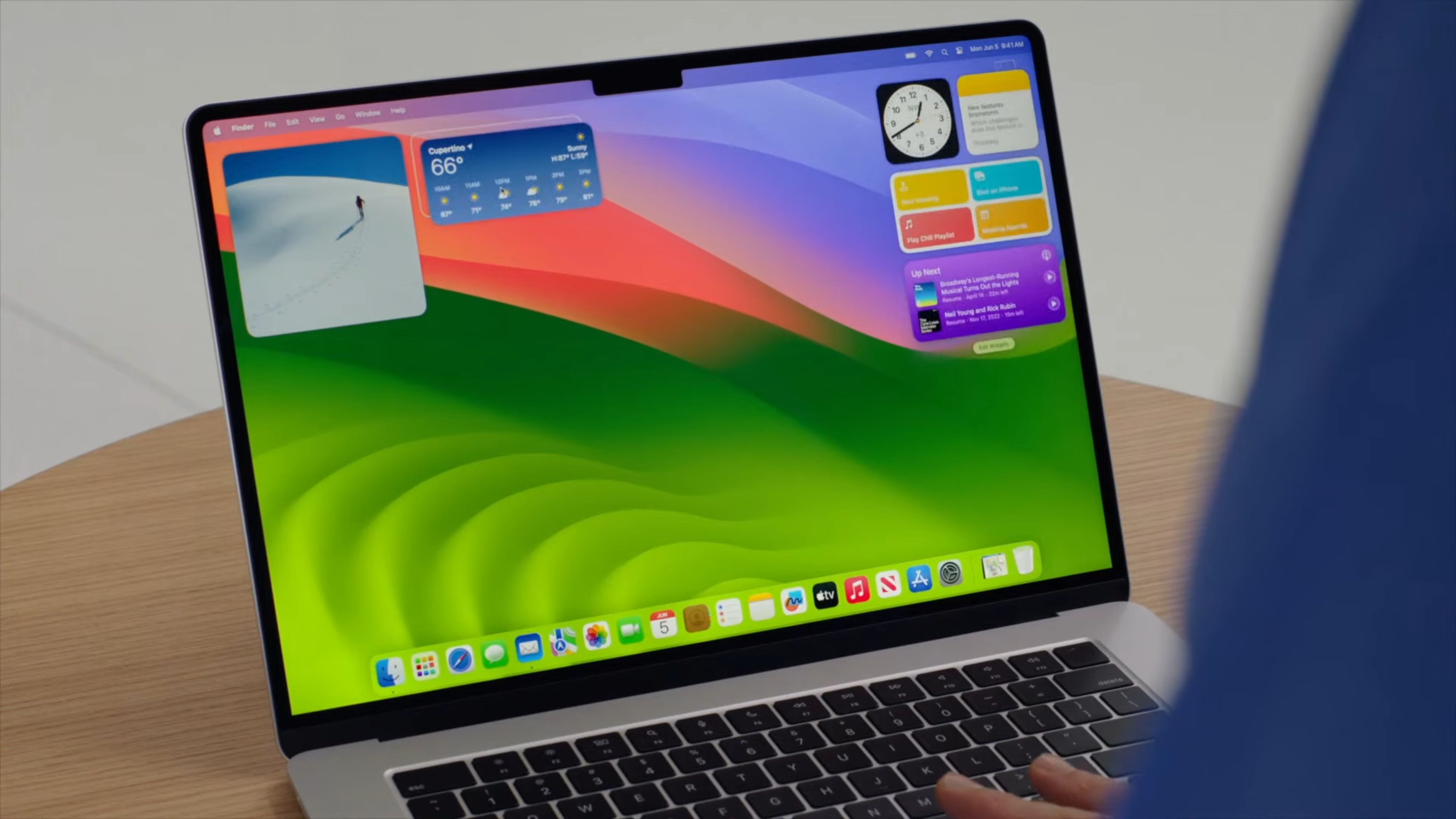 A MacBook running macOS Sonoma with widgets on the desktop