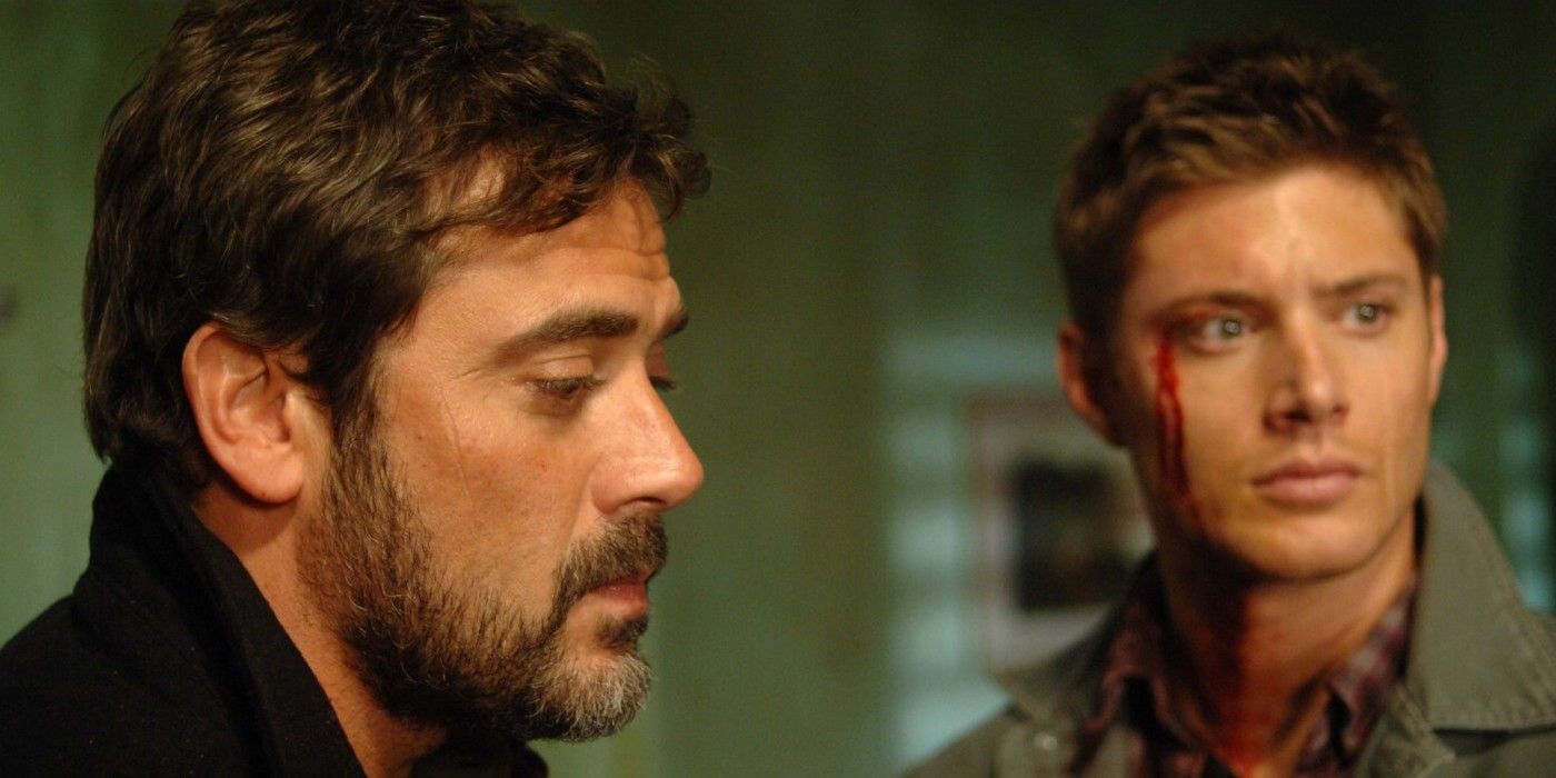 John Winchester looking forlorn in front of a bloodied Dean Winchester in Supernatural.