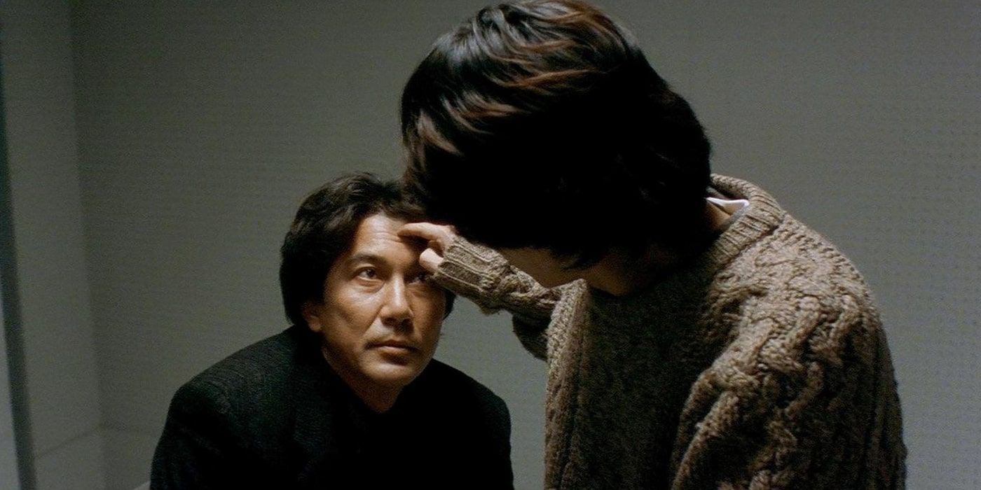 Mamiya (Masato Hagiwara) touches Takabe's (Kōji Yakusho) face in Cure.