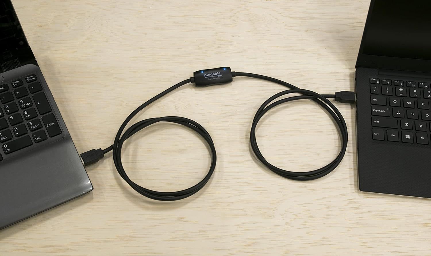 USB 3.0 transfer cable connected to two laptops.