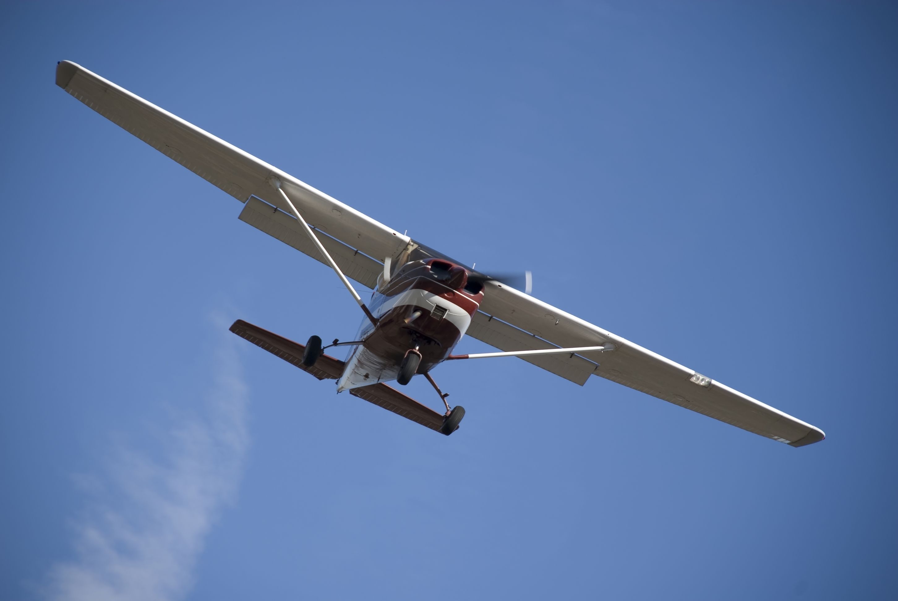 A Cessna 172 flying in the sky.