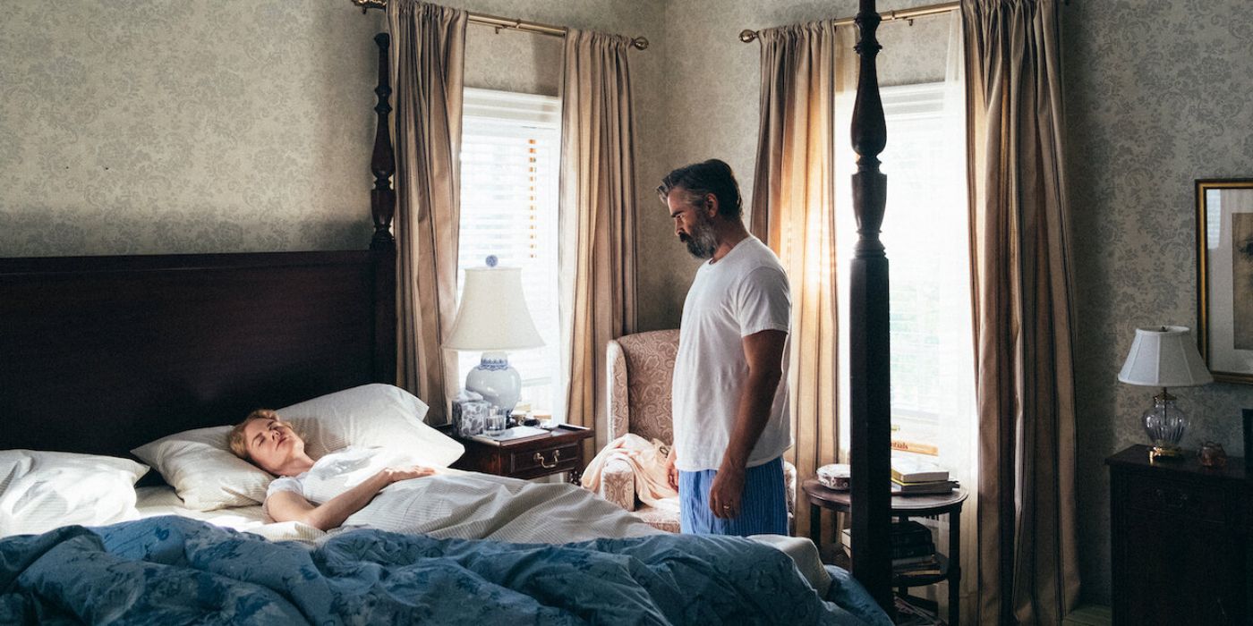 Colin Farrell looking down at a sleeping Nicole Kidman in 'The Killing of a Sacred Deer'