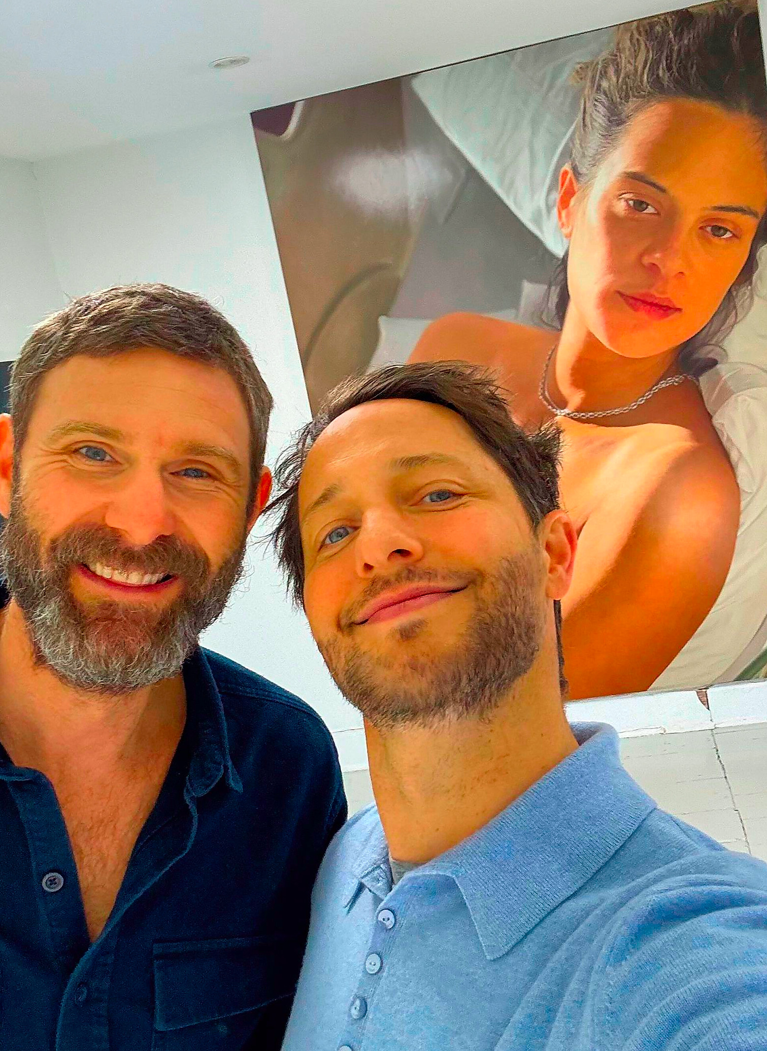 selfie taken in an art gallery with a large painting in the background
