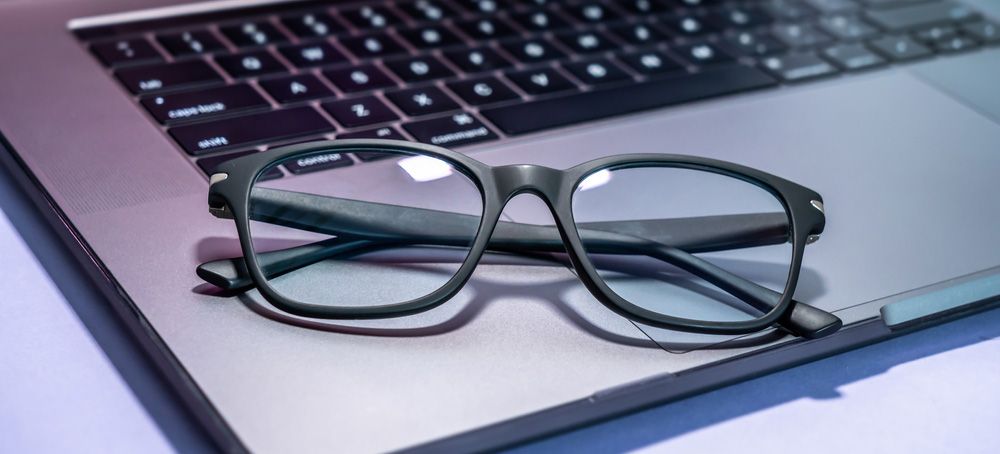 Blue light filter eyeglasses on a laptop