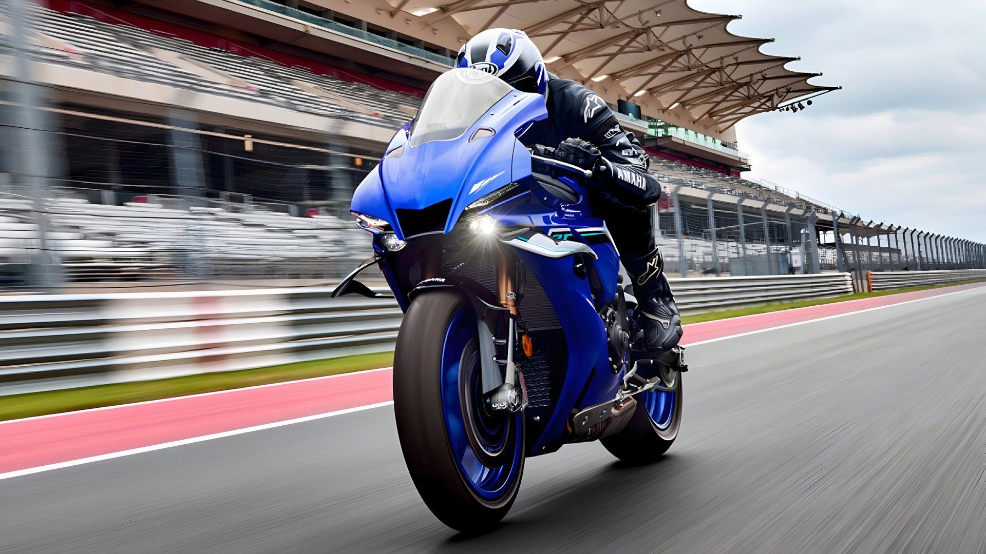 2025 Yamaha R1 accelerating on a racetrack front third quarter view