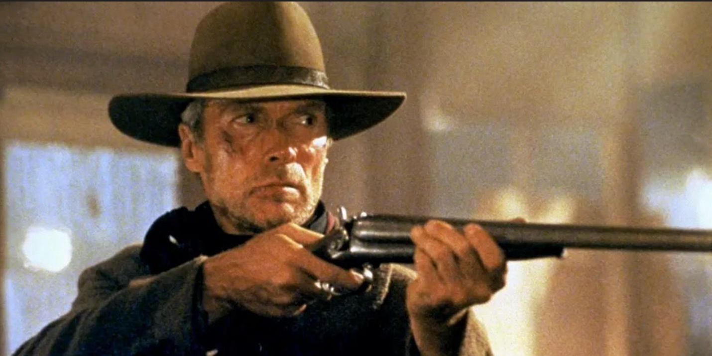 William Muny aims his rifle at someone off camera in Unforgiven