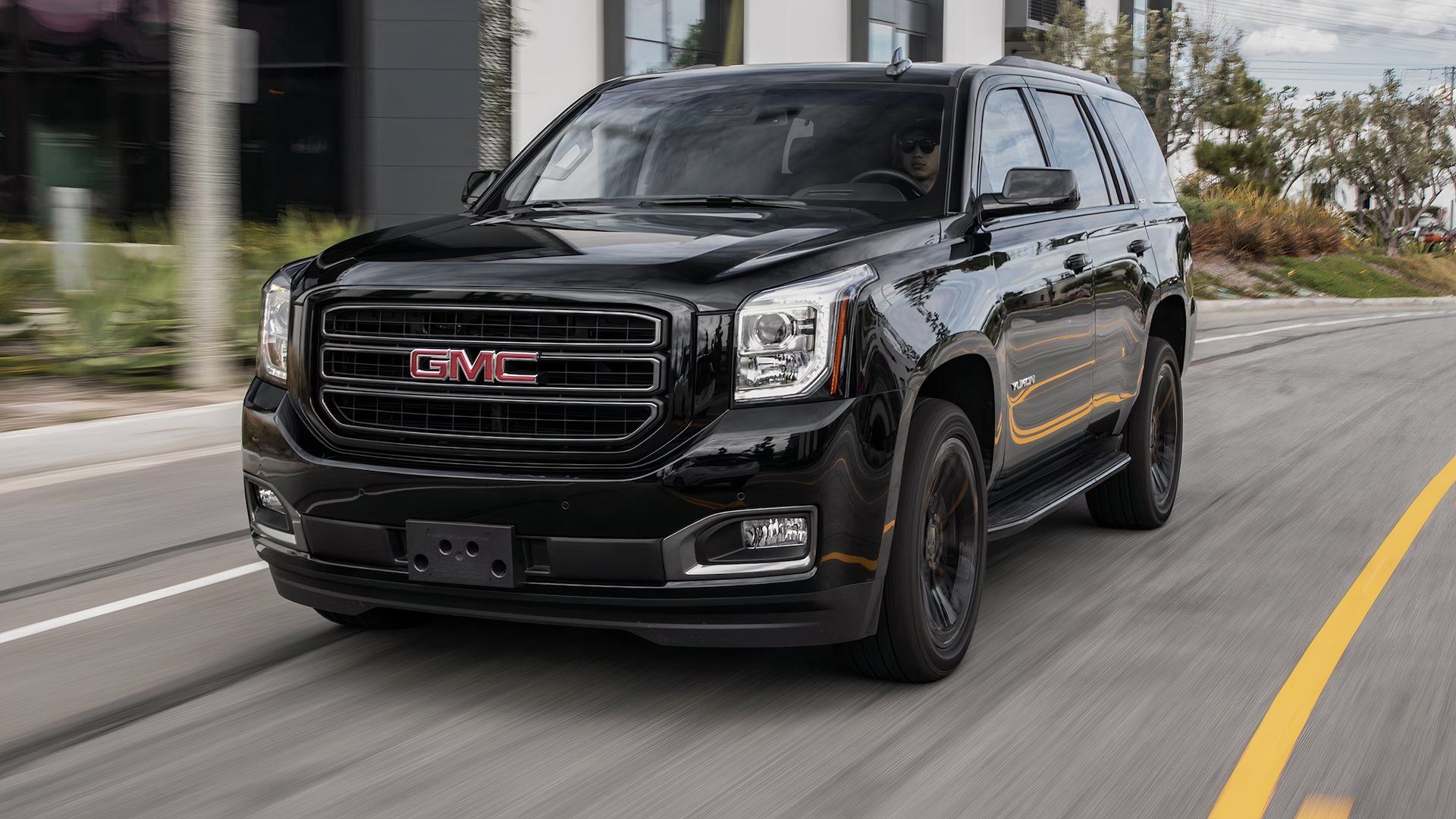 2019 GMC Yukon in black driving on road