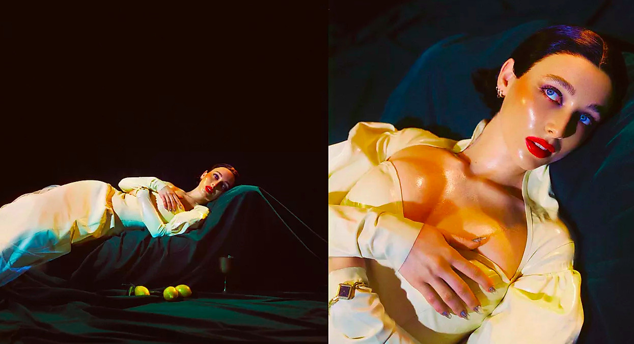 Emma Chamberlain in a latex dress lounging on green velvet