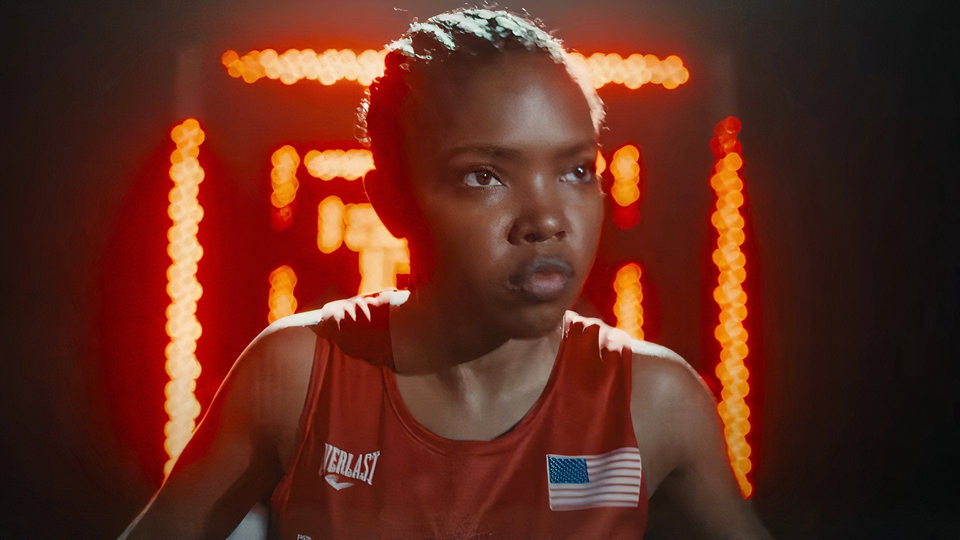 Ryan Destiny as Claressa Shields in front of red lights in the 2024 movie The Fire Inside