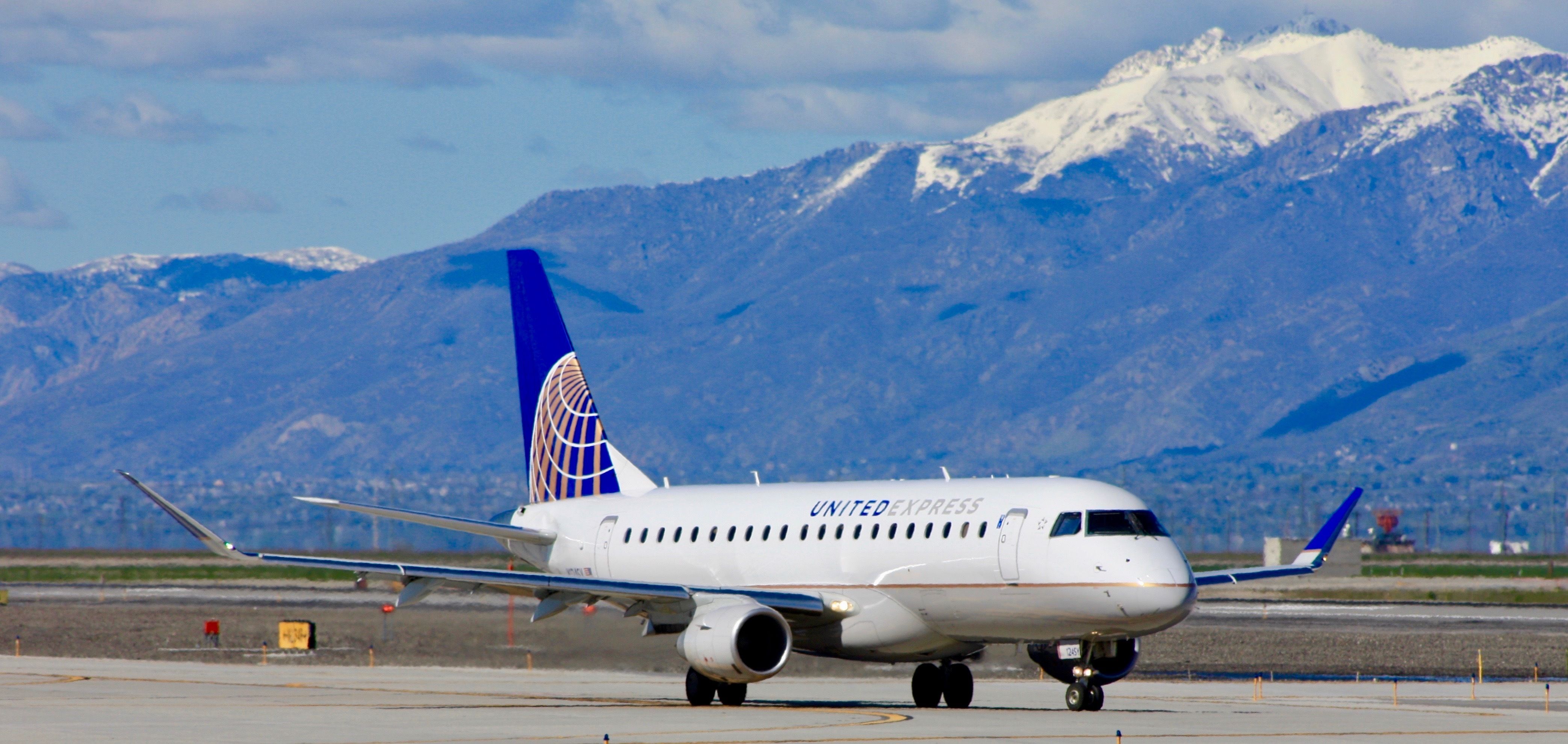 A United Express Embraer E175 on an airport apron. 